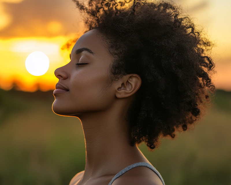monica_uthlaut_somatic_psychotherapist_st_louis Black woman feeling peaceful in the sun